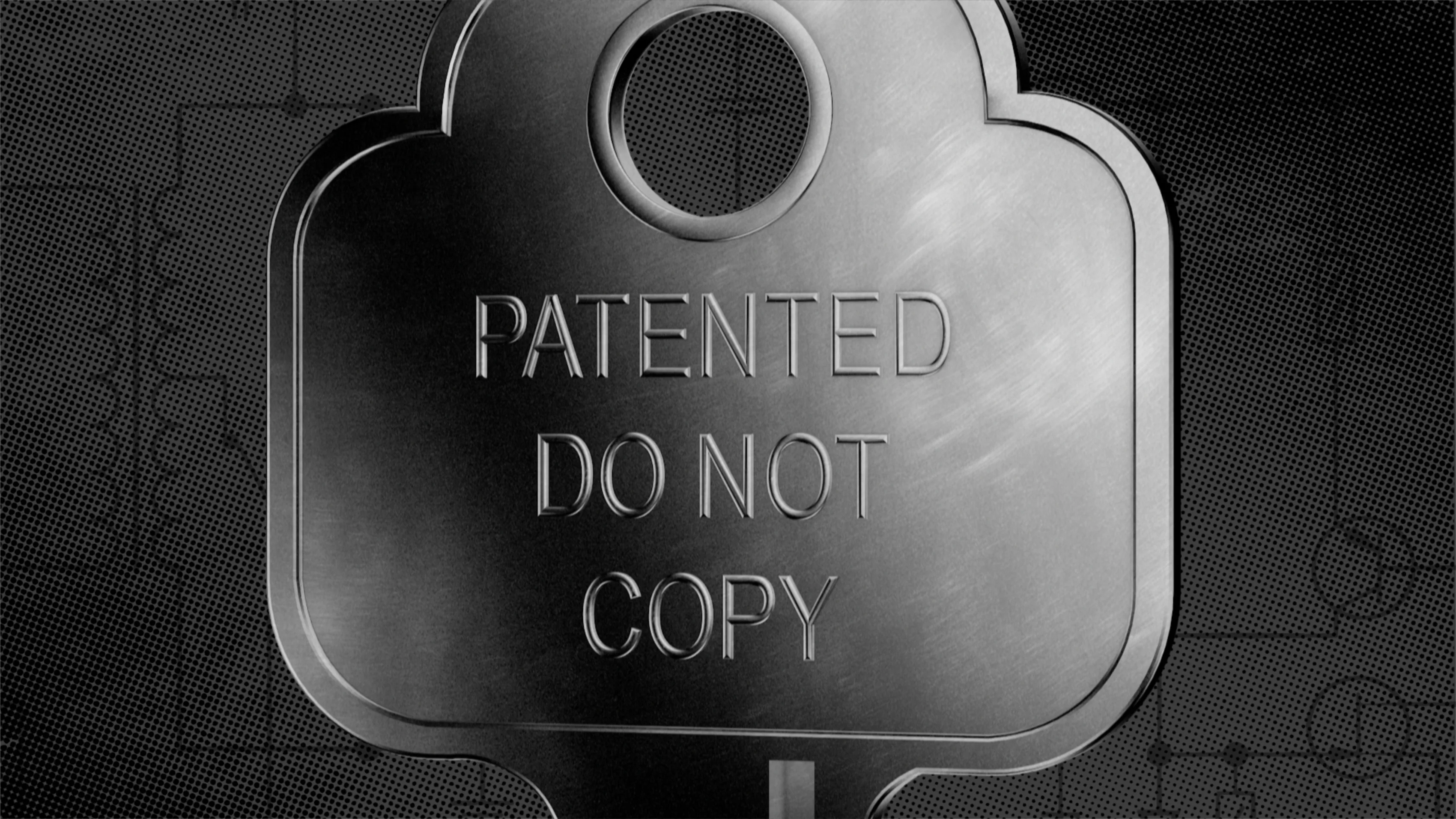 A cast Banham lock plate reading Patented Do Not Copy, on a dark halftone ground marked with faint technical drawings.