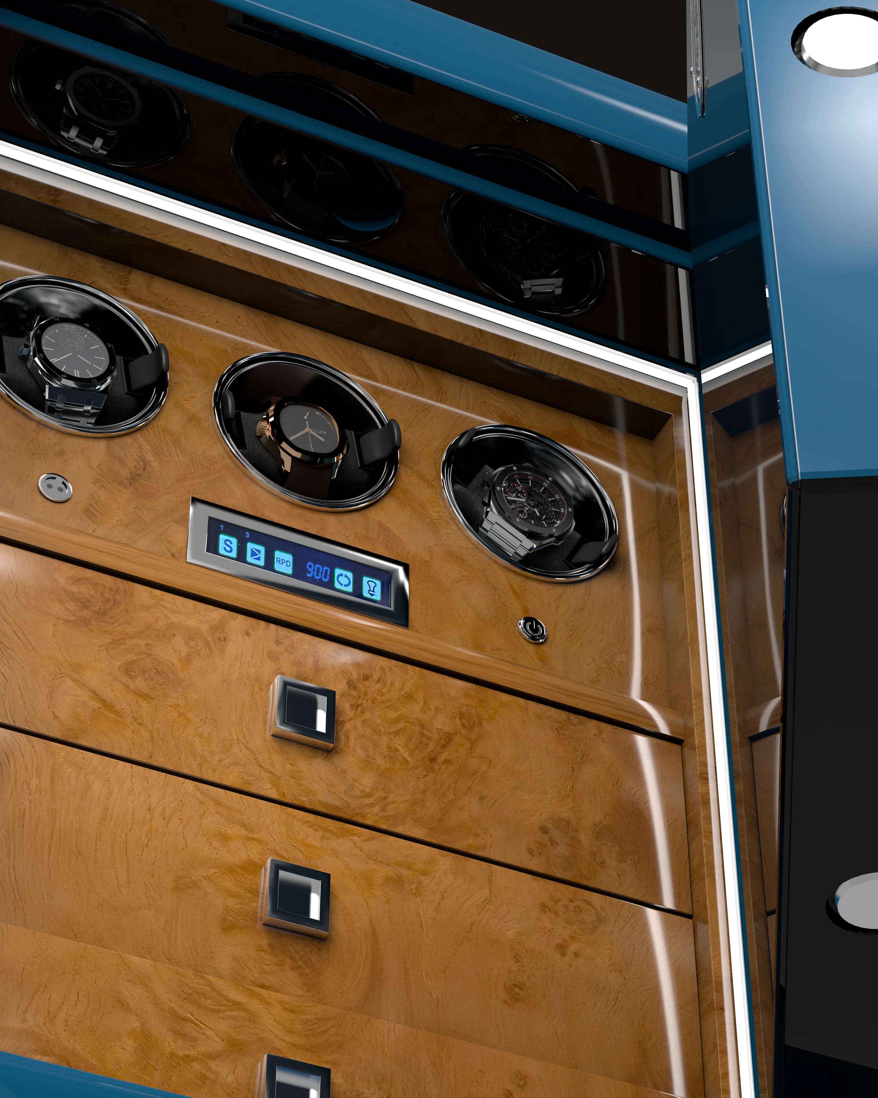 The interior of a Banham safe, its burr-walnut fascia set with three lit watch winders above a bank of drawers.