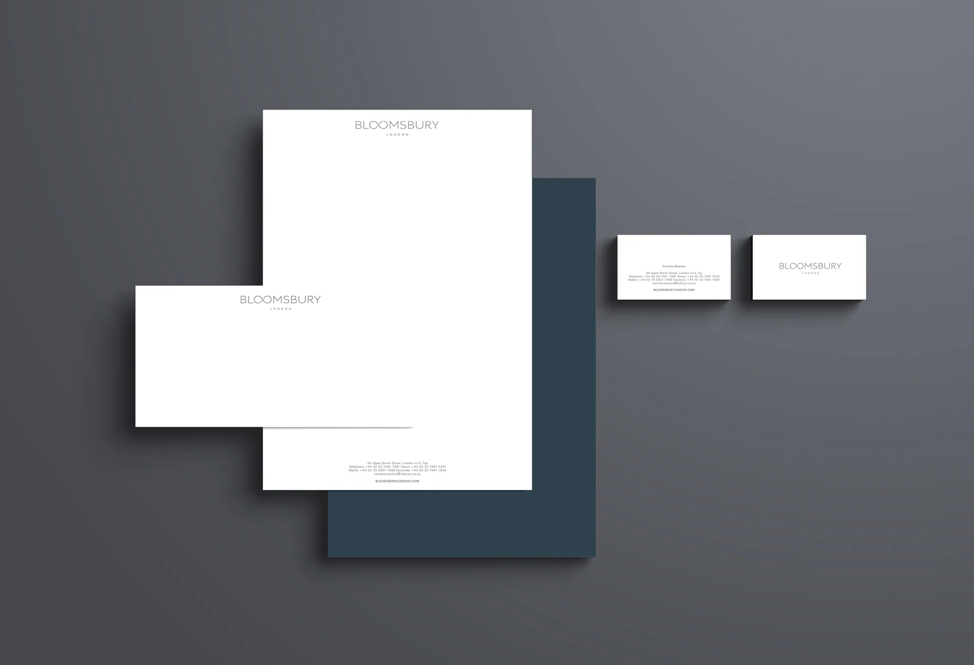 The Bloomsbury stationery, a letterhead and cards laid on a teal folder.