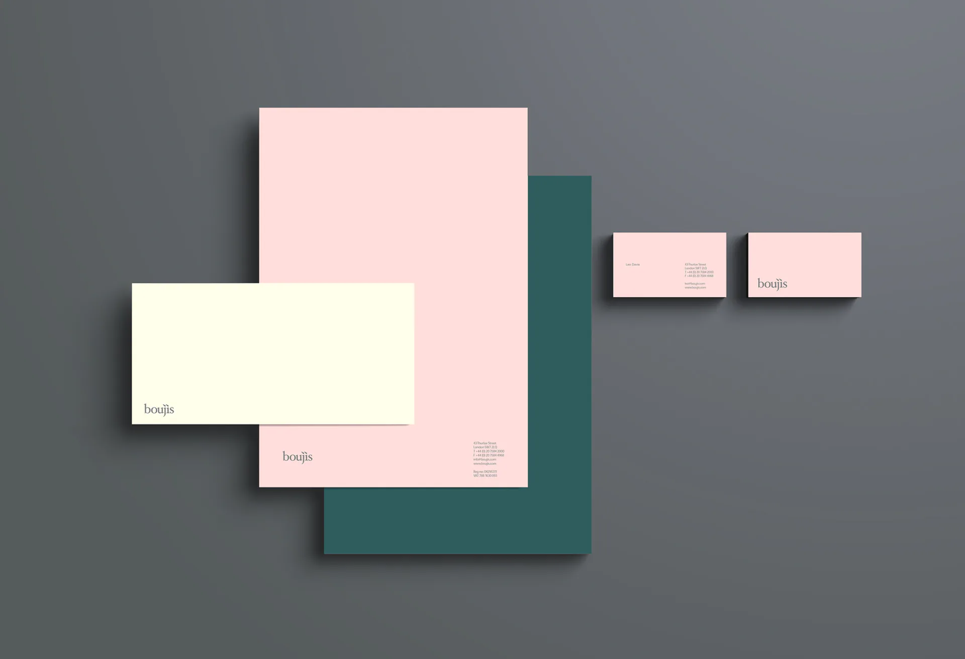 The Boujis stationery in pink, cream and teal, laid out on grey.