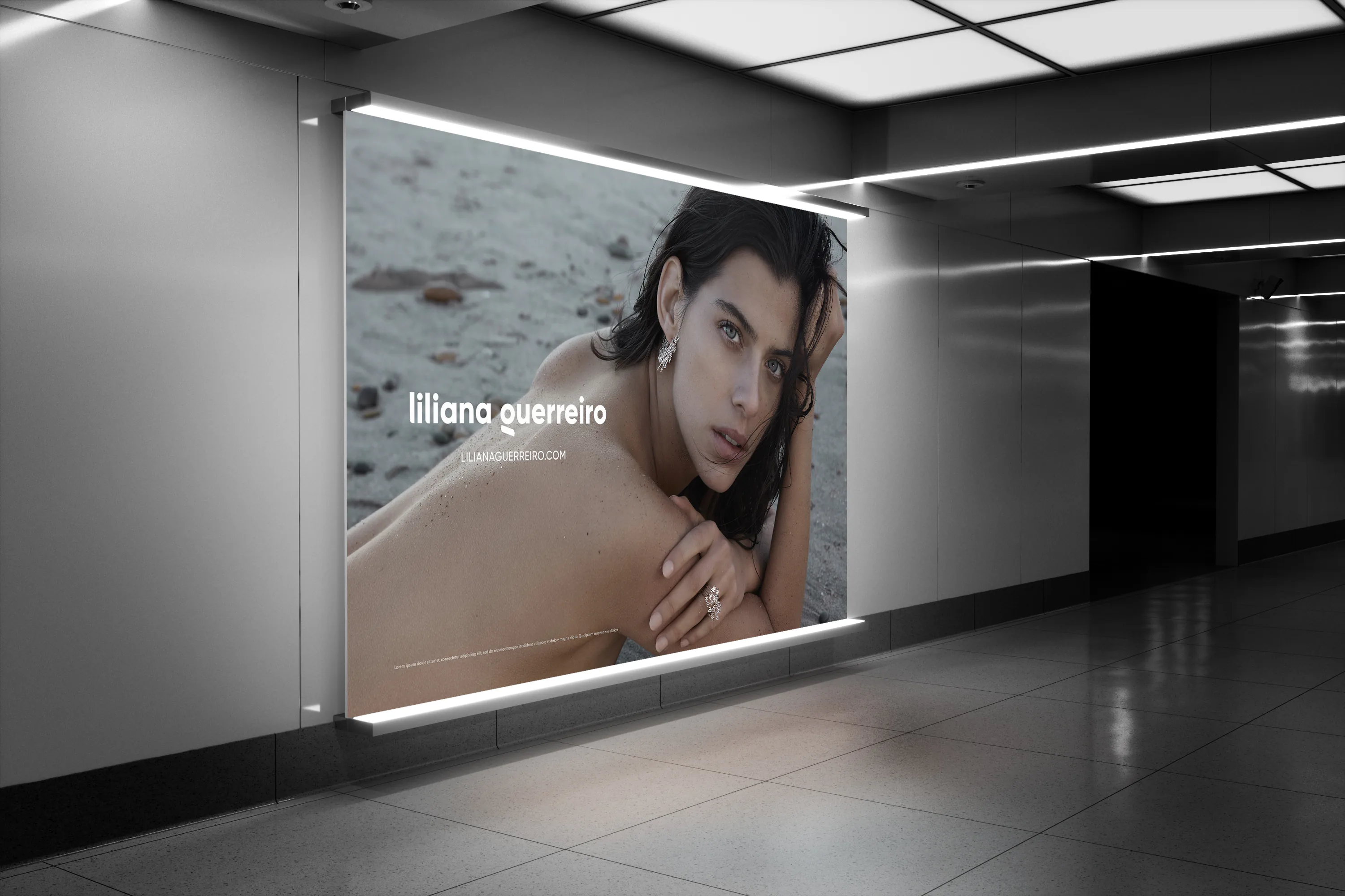 A lit campaign billboard in a station concourse, the logotype beneath the image.