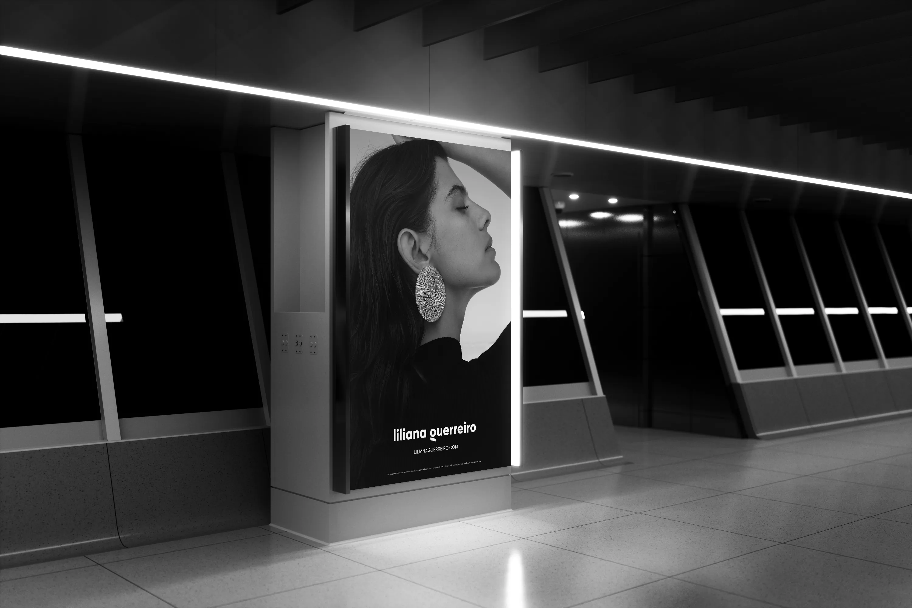 A lit campaign billboard on a station platform, the logotype beneath the image.